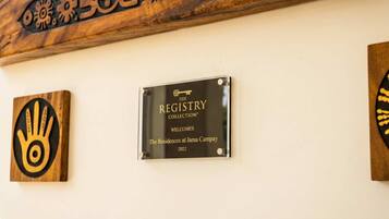A plaque on a wall with the text 'The Registry Collection Welcomes The Residences at James Campay 2022'.