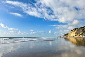 A beach with a clear sky and calm sea.