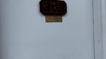 Porta com placa de proibido fumar e número do quarto.