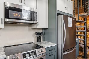 A modern kitchen with a built-in stove, oven, and stainless steel refrigerator. - Two Bedroom, Two Bath with Easy Ski Access and Mountain Views (Breckenridge)