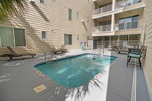 A swimming pool with lounge chairs and a covered patio area. - Brand New!Spacious Oceanview Holiday Villa | 4 Private Ensuites | Steps to the Sand (North Myrtle Beach)