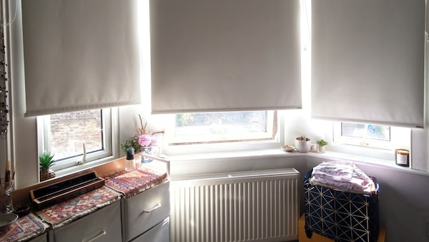 A room with a radiator, a window with a view, a desk with drawers, and a suitcase. - Cute studio apartment on café street close to music venues and camden (London)