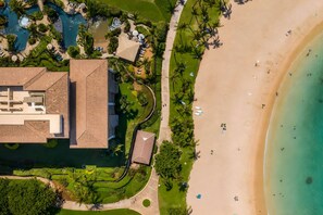 A resort with a large building, a beach, and a pool area. - Beachfront 2 Condos at Ko Olina Beach Villas · 6 BR · Sleeps 16 (Kapolei)