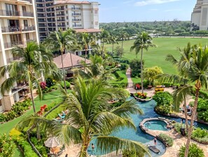 A resort with a swimming pool, palm trees, and a view of a hill. - Ko Olina, Ko Olina Beach Villas, Spacious 6 BR, Beachfront, Sleeps 16 (Kapolei)