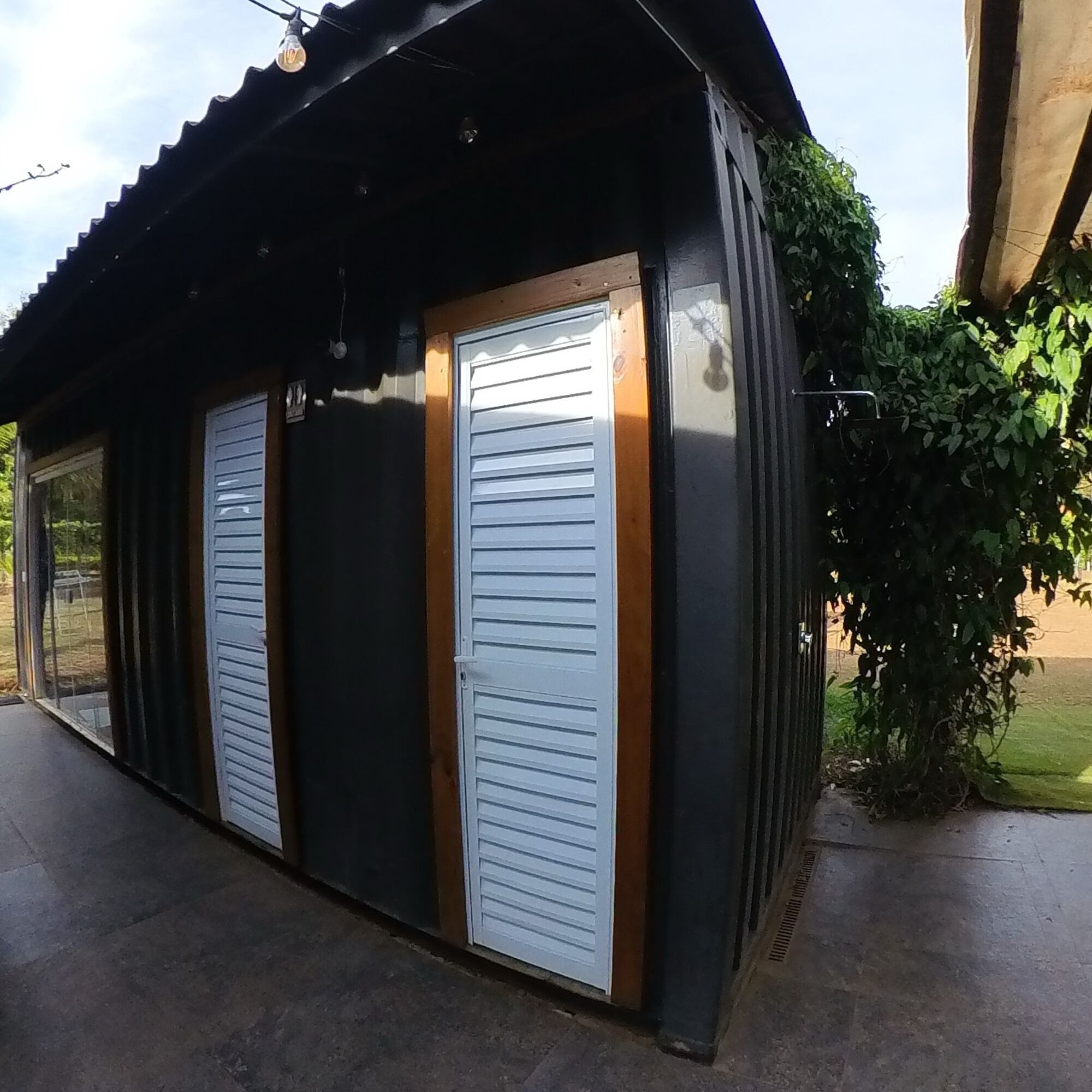 A building with two closed garage-style doors and a small overhang.