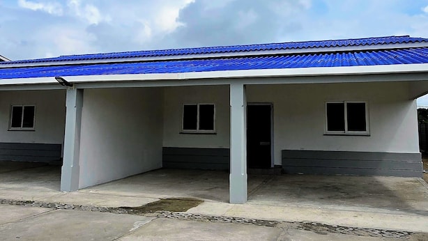 Een gebouw met een blauw dak en een overdekte entree.