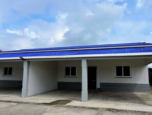 A building with a blue roof and a covered entrance area.