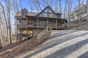 A multi-level wooden cabin with a deck and a staircase leading to the upper levels. - Blue Ridge Escape | Luxury Mtn. Cabin near Lake BR (Blue Ridge)