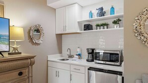 A modern kitchen with white cabinetry, a built-in microwave, and a coffee maker. - Coastal Comfort at TOPSL Summit 309C (Miramar Beach)