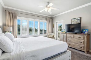 A bedroom with a large bed, a ceiling fan, a television, and a dresser. - Coastal Comfort at TOPSL Summit 309C (Miramar Beach)