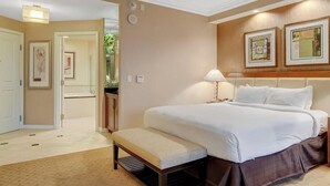 A hotel room with a large bed, a bench, a bedside table with a lamp, and framed artwork on the wall. - MGM Signature-08-704 Jacuzzi Studio (Las Vegas)