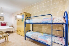 A bunk bed with a wooden wardrobe and a single bed with a floral bedspread. - Villetta Lea by BarbarHouse (San Pietro in Bevagna)