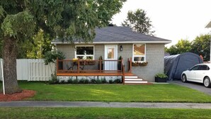 A single-story house with a front porch, a garage, and a tent in the driveway. - Otto Street, Osgoode. (osgoode)