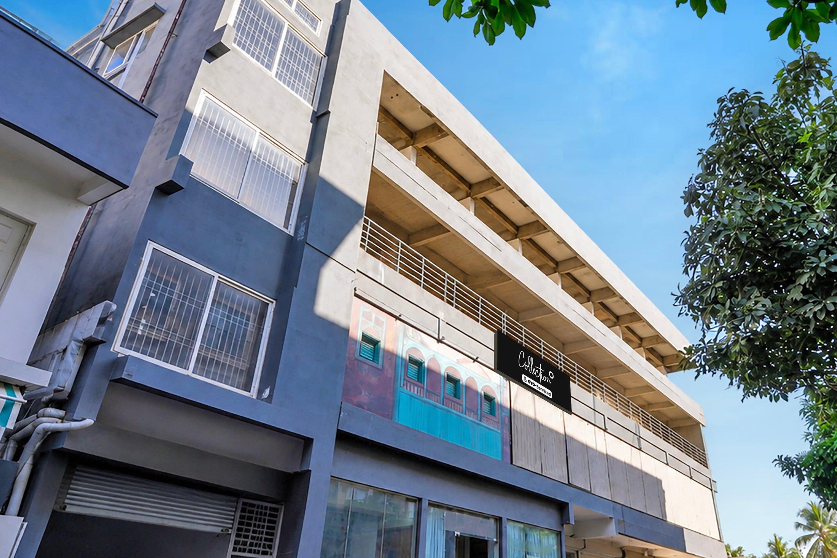 A multi-story building with a flat facade, large windows, and balconies.