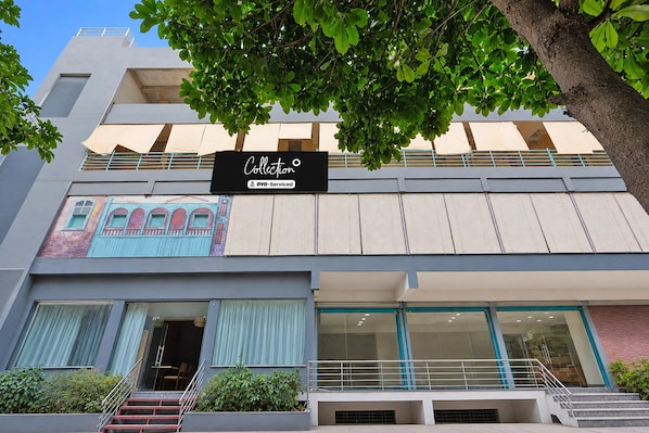 A multi-story building with a storefront labeled 'Collection' and 'OYO-Serviced.' - Collection O Thanisandra Bangalore (Bengaluru)