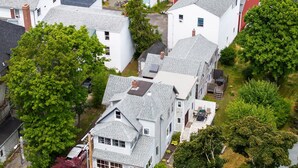 A residential area with multiple houses, including a two-story house with a visible front porch and a garage. - Spacious Harbor Retreat | Easy Access to Downtown (Mount Desert)