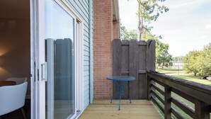A wooden deck with a glass door leading to a patio area. - The Redbird, Walk to Square, VelvetDitchVillas (Oxford)