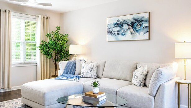 A living room with a sectional sofa, a glass coffee table, a potted plant, and a painting on the wall. - The Redbird, Walk to Square, VelvetDitchVillas (Oxford)