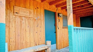 A wooden building with a door marked '182 rooms 284 beds'.