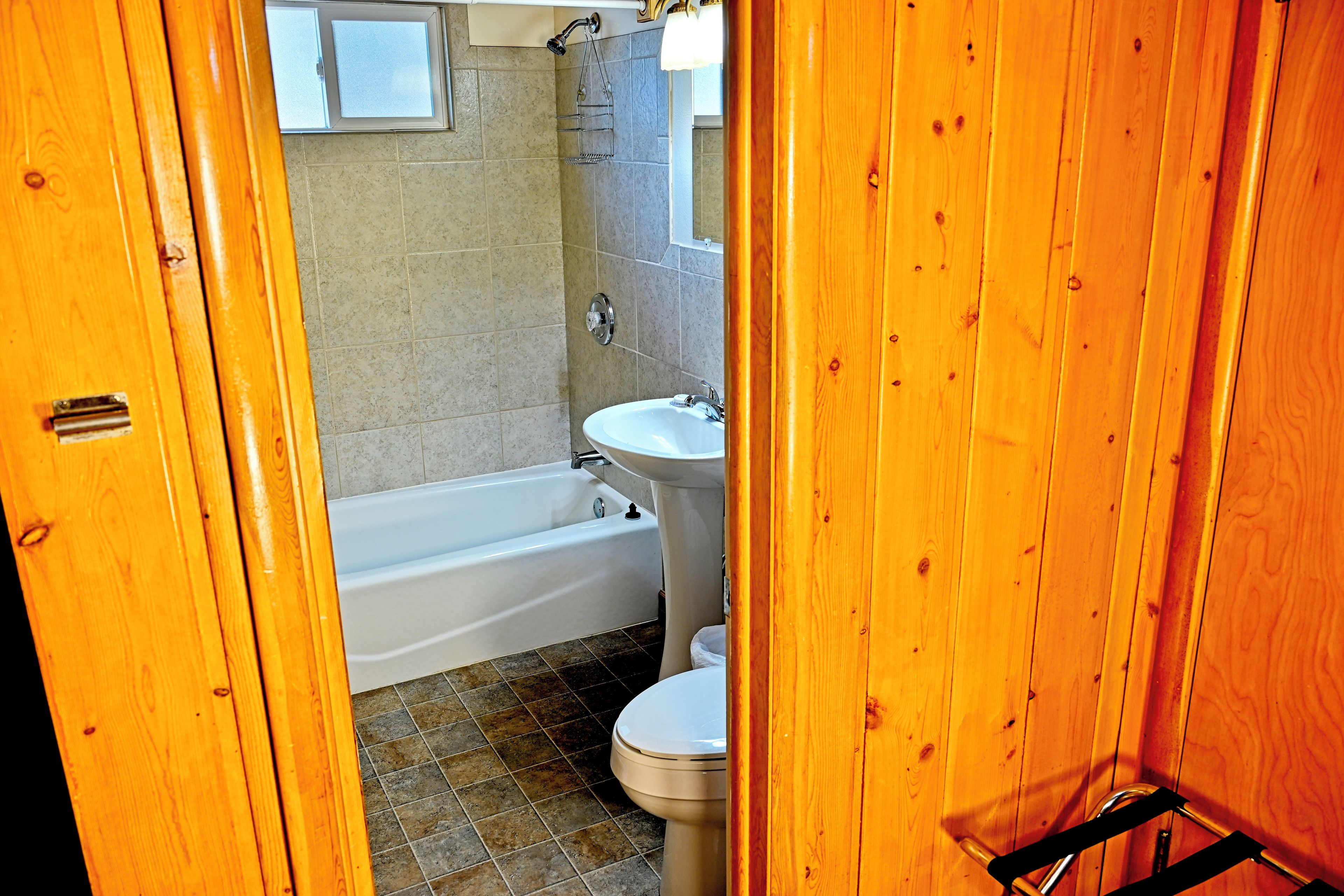 A bathroom with a bathtub, sink, and toilet.