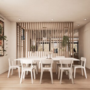 A modern dining area with a white table and chairs, wooden slats, and a view of the outdoors. - Summer 2027 - Brand New Luxury Vacation Rental in Lewes, Delaware, 5 bedrooms (Lewes)