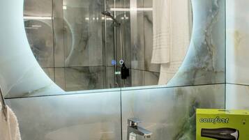 Shower, hair dryer, towels, toilet paper