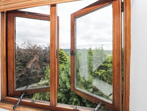 A window with a view of a forested landscape. - Penrhiwoli Barn (Llangammarch Wells)