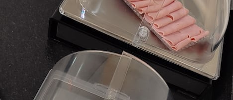 A food display with sliced bread and ham.