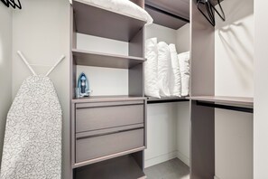 A neatly organized closet with shelves, drawers, and hanging space for clothes and accessories. - The Crosby Balcony 1BR by Palermo Home  (Miami)