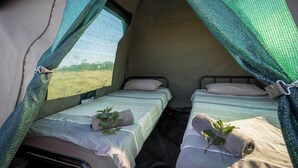 A tent with two beds, each with a pillow and a plant. - Satara Wild Camp- Greater Kruger (Mpumalanga)