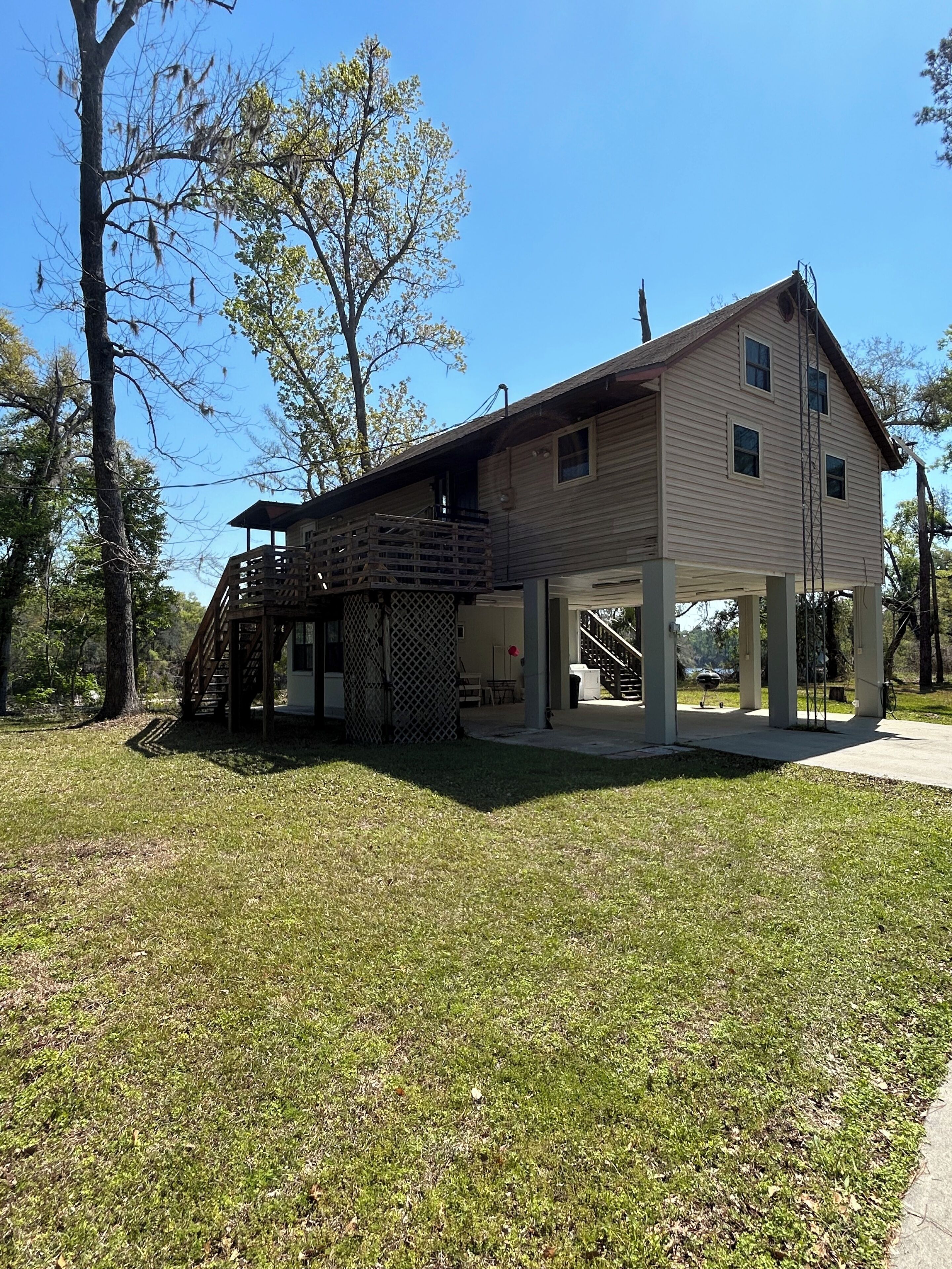 A two-story building with a covered porch and a staircase leading to an upper level.