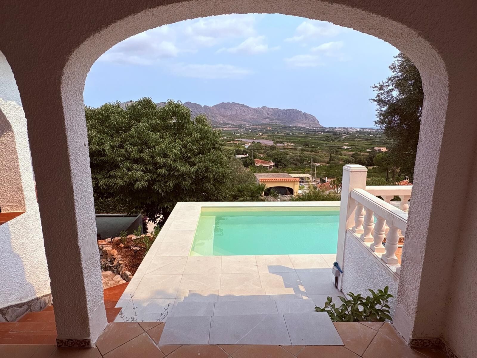 A pool area with a view of a mountainous landscape.