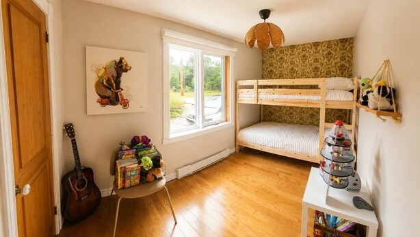 A child's bedroom with a bunk bed, a guitar, toys, and a window with a view of the outside. - A beautiful cabin with a private lake. (Saint-Cã´Me)