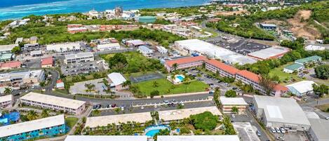 An aerial view of a coastal town with buildings, roads, and a beach.