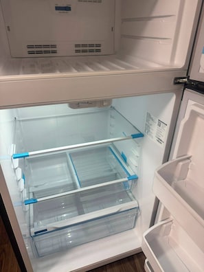 An empty refrigerator with clear plastic bins and a control panel with temperature settings. - Enjoyable 1-bedroom apartment in lovely Regina with AC (Regina)