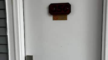 A white door with a number plate reading '350' and a non-smoking sign below it.