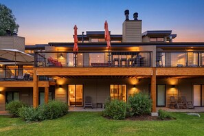 A modern two-story building with a balcony, outdoor seating, and a well-maintained lawn. - New Listing! Pet Friendly Townhome - Fenchurch Trails (Park City)