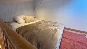 A bedroom with a bed, a wooden headboard, a white wall, and a ceiling with recessed lighting. - A cozy little retreat on Penotte Island (Les Sables-d'Olonne)