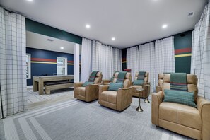 A room with a sofa set, a table, and a bench.