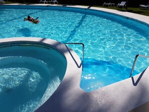 A swimming pool with a curved edge and a built-in hot tub section. - Bamboo House, Oceanfront, Las Terrenas, Punta Popi. Comfort, convenience, and magic. (Las Terrenas)