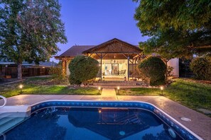 A residential property with a swimming pool, a covered patio, and a well-maintained lawn. - Newly remodeled, stunning Italian 3BR/3BA cottage with pool, RV parking/hookups (Redding)