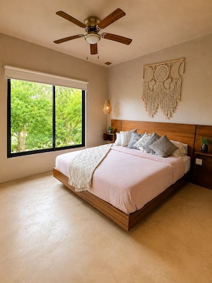 A bedroom with a bed, a ceiling fan, a large window, and a wall decoration. - Modern Tulum Penthouse ● Private Plunge Pool ● Fast WiFi ● Gym (Tulum)
