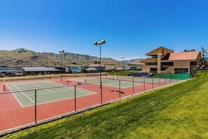 An outdoor tennis court with a building in the background. - Lake Chelan Shores Waterfront Dream #11-4 Pools Hot Tub Beach Tennis Boating (Chelan)
