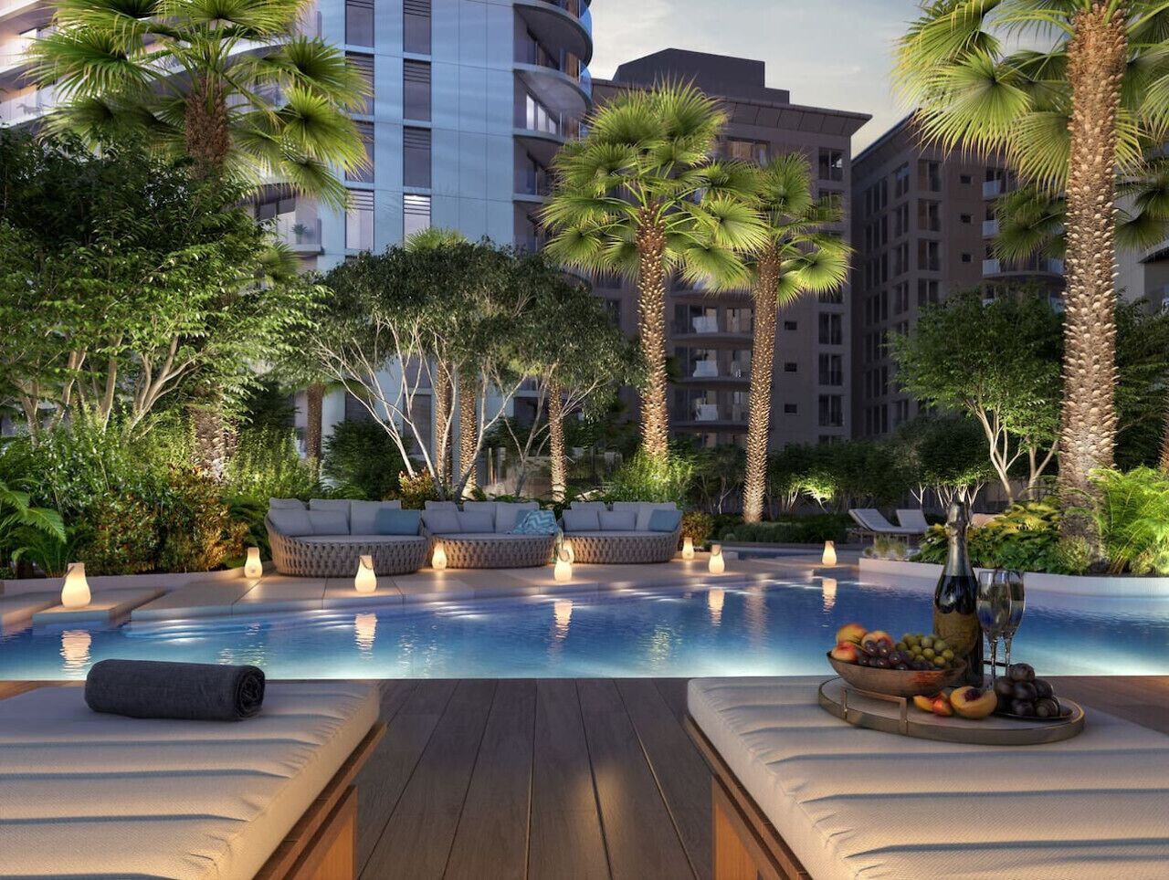 A pool area with lounge chairs, a wooden deck, and a fruit and wine display.