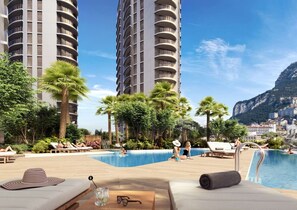 A hotel pool area with lounge chairs, a small pool, and a view of tall buildings and a mountain. - Skyline Studio EuroCity | Pool & Gym | City Centre (Gibraltar)