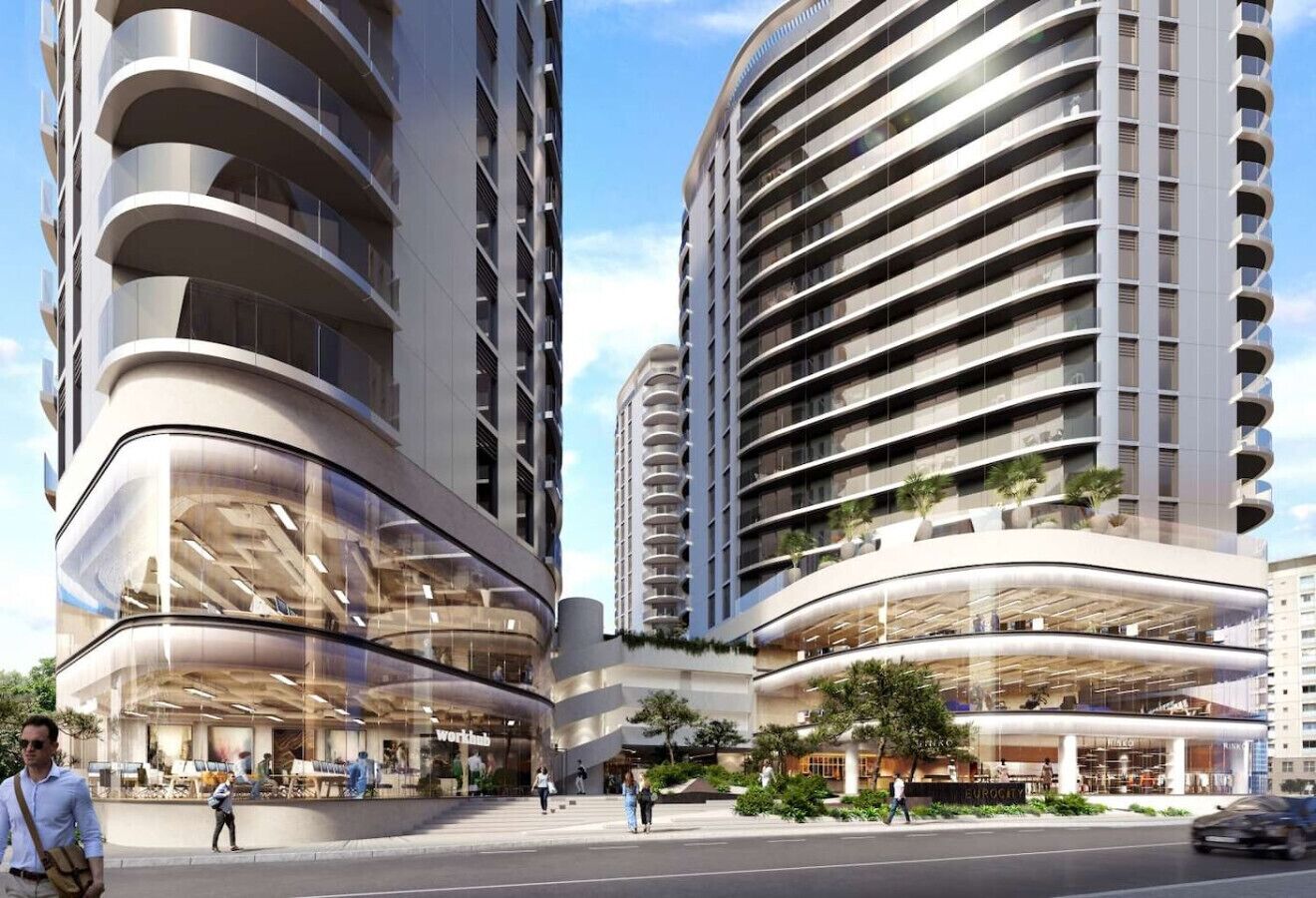 A modern high-rise building with curved balconies and a glass facade.