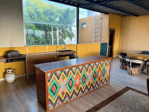 A kitchen with a wooden counter, a window, and a view of greenery outside. - Ocean View Apt 1 Block to Beach and Marina (Cruz de Huanacaxtle)