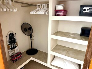 A room with a white shelving unit, a standing fan, and a wheelchair. - Rooftop Patio, Marina Views––1 Block to Beach (La Cruz de Huanacaxtle)