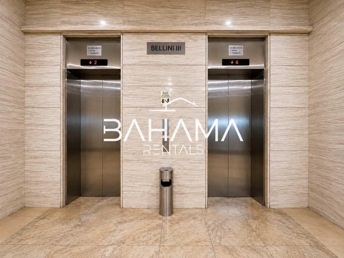 An elevator area with two elevators, each marked with a floor indicator and a sign for 'BELLINI III'. A trash bin is placed in the center.