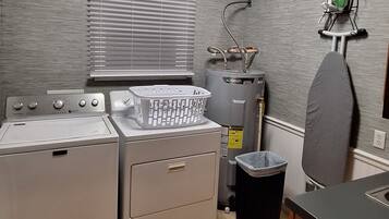 A laundry area with a washer, dryer, and a water heater.